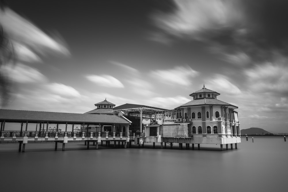 black and white picture of a building on water
