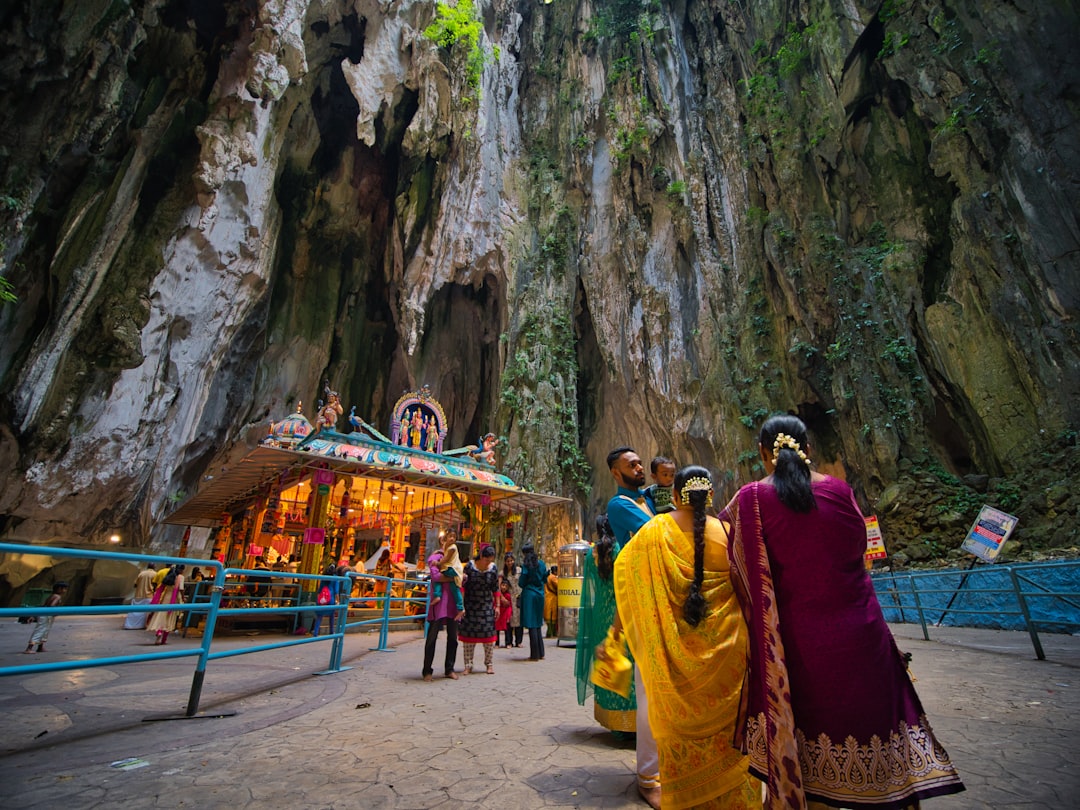two women wearing salwar kameez near mountain cliff,