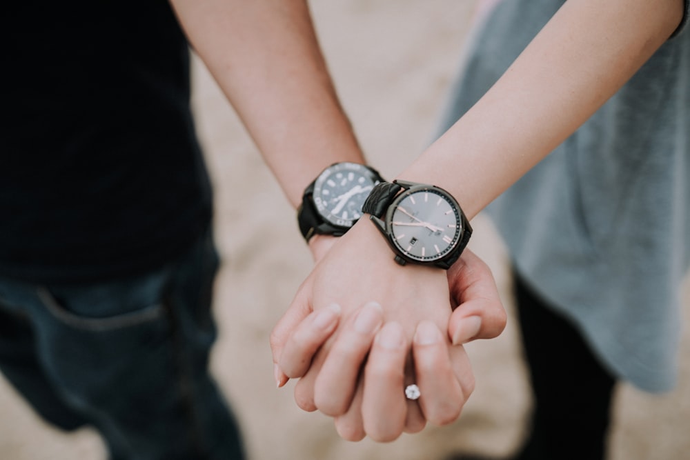 two person wearing couple watch