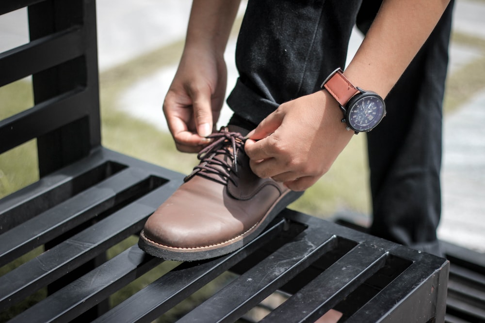 man tying a shoe lace