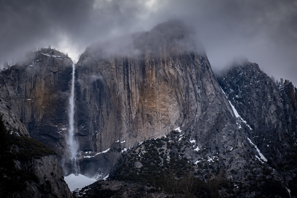 mountain cliff under nimbus clouds