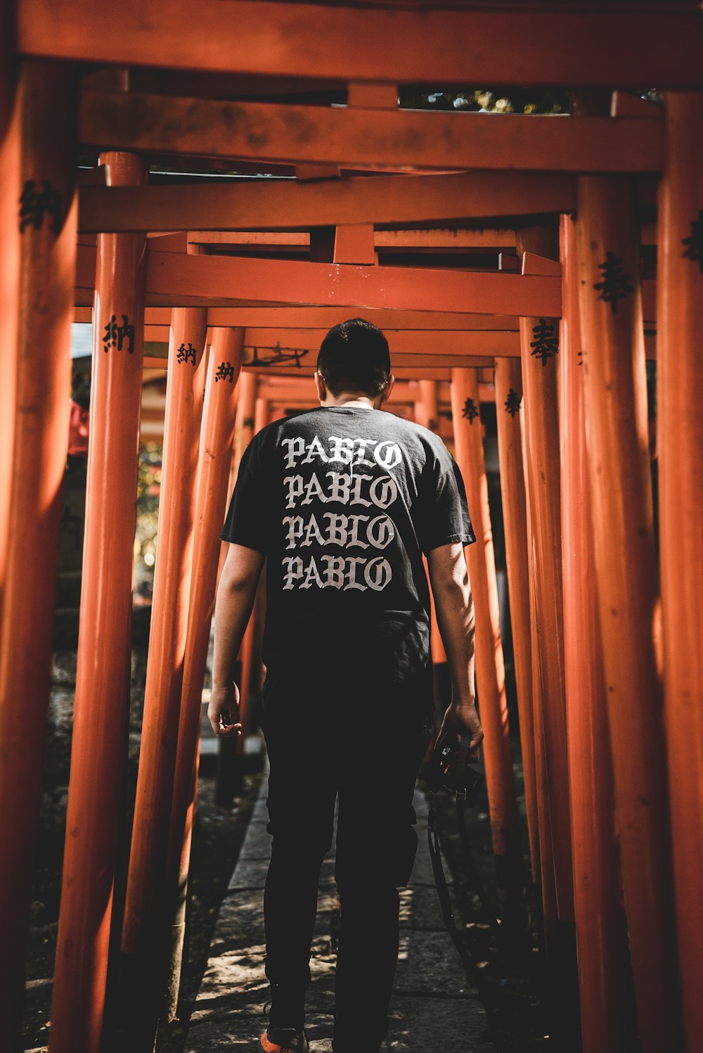 man walking on arch shrines