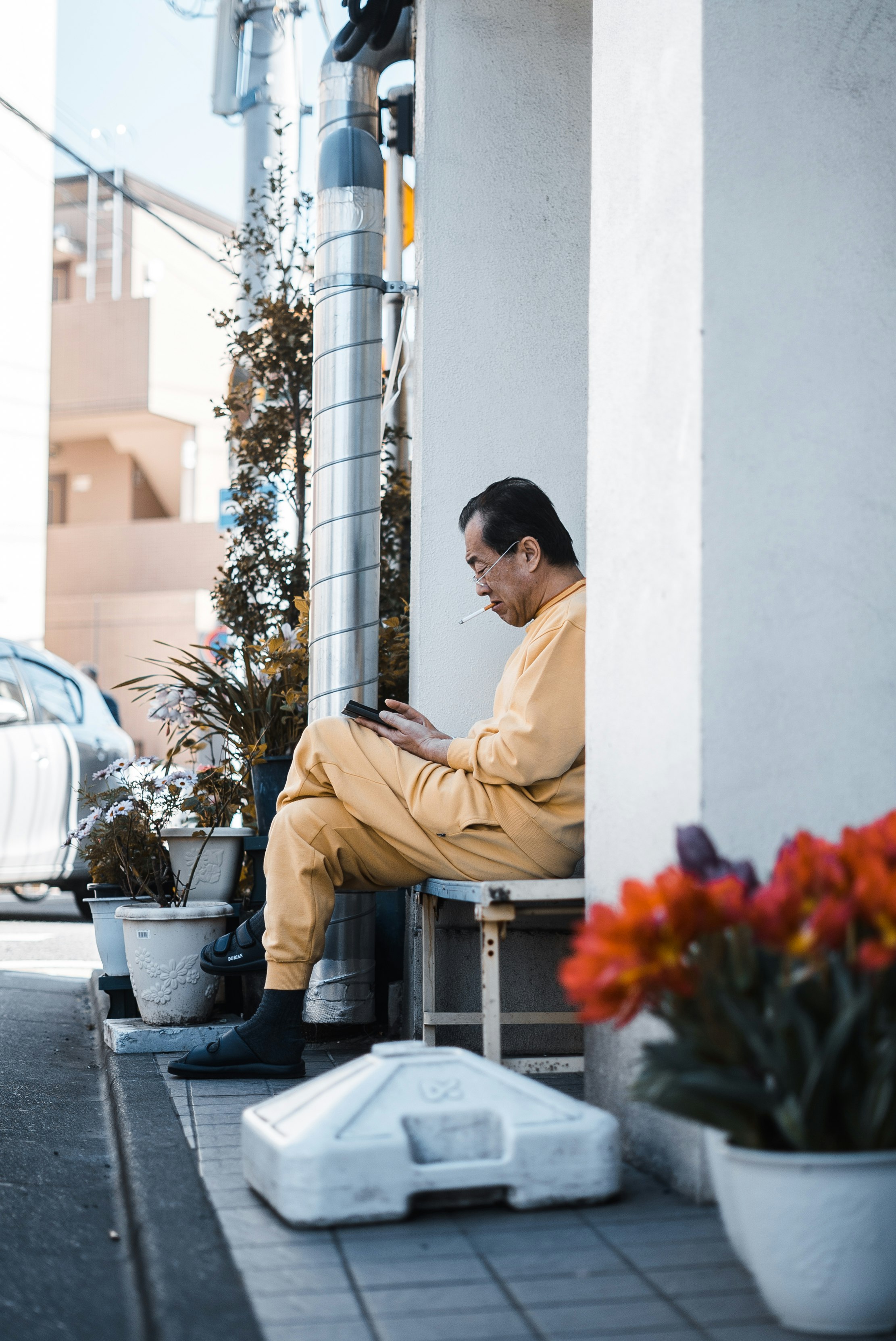 seated man in a yellow jumpsuit