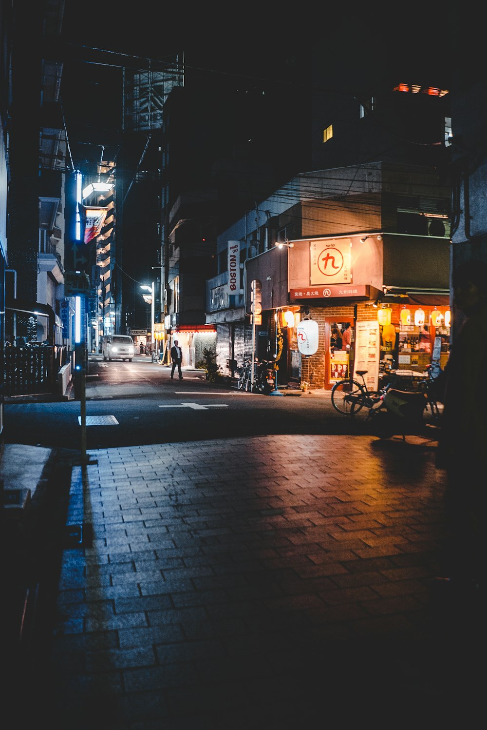 man standing on street near store