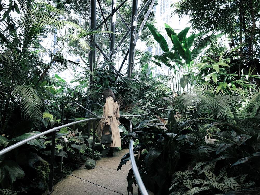 woman standing beside plants