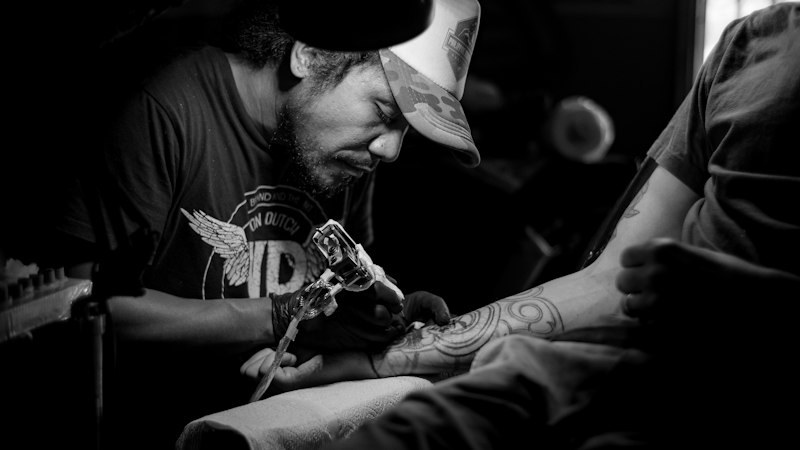 Tattoo artist finishing a detailed piece