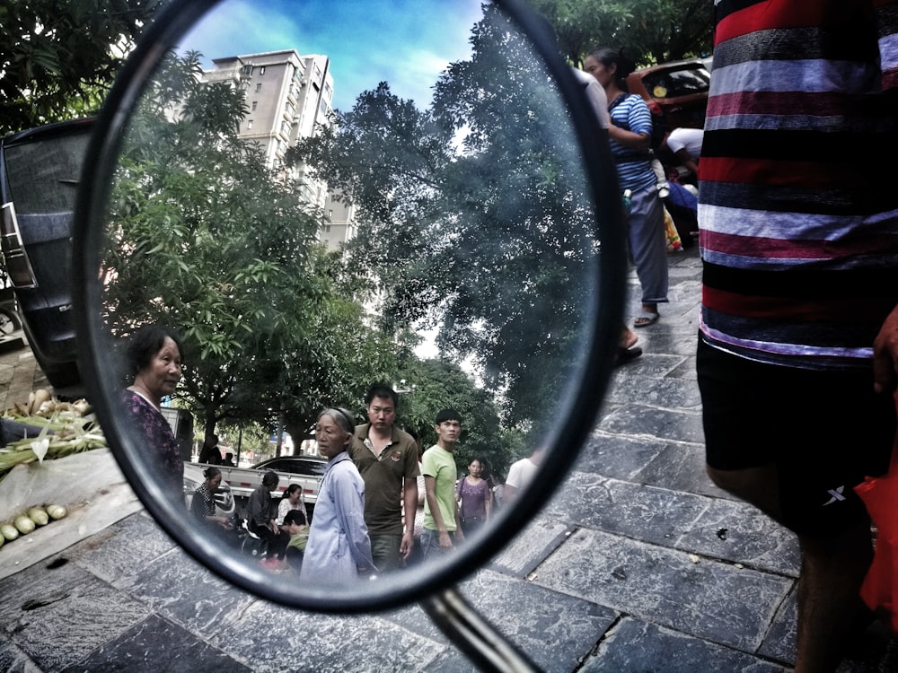 side mirror reflection of people