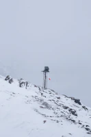 Wind speed and direction map with arrows over a mountainous landscape