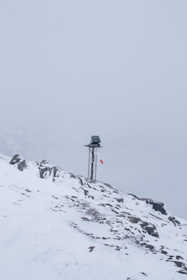 Environmental impact study team measuring snow and ice conditions near a solar installation.