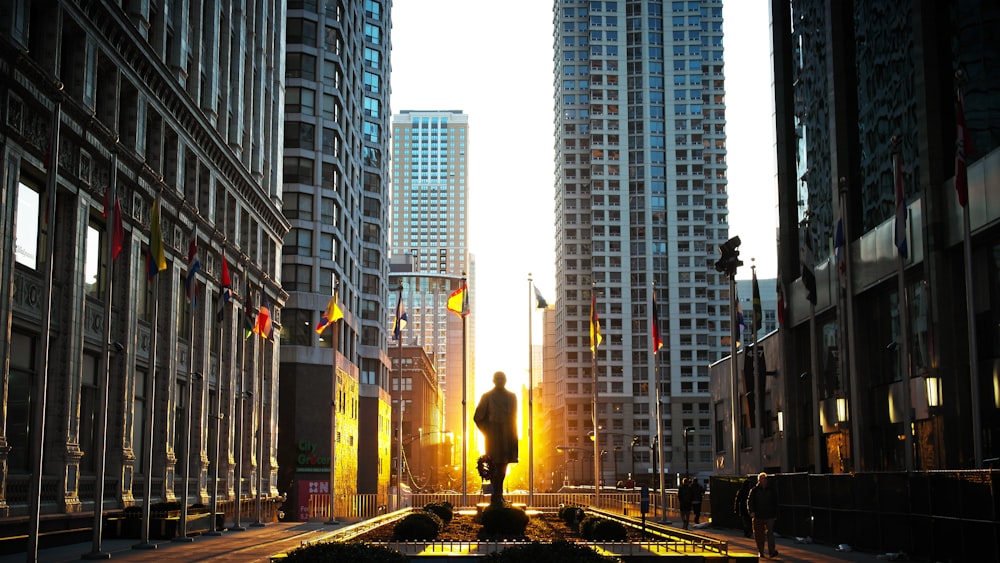 silhouette of statue at the park surrounded by high rise building