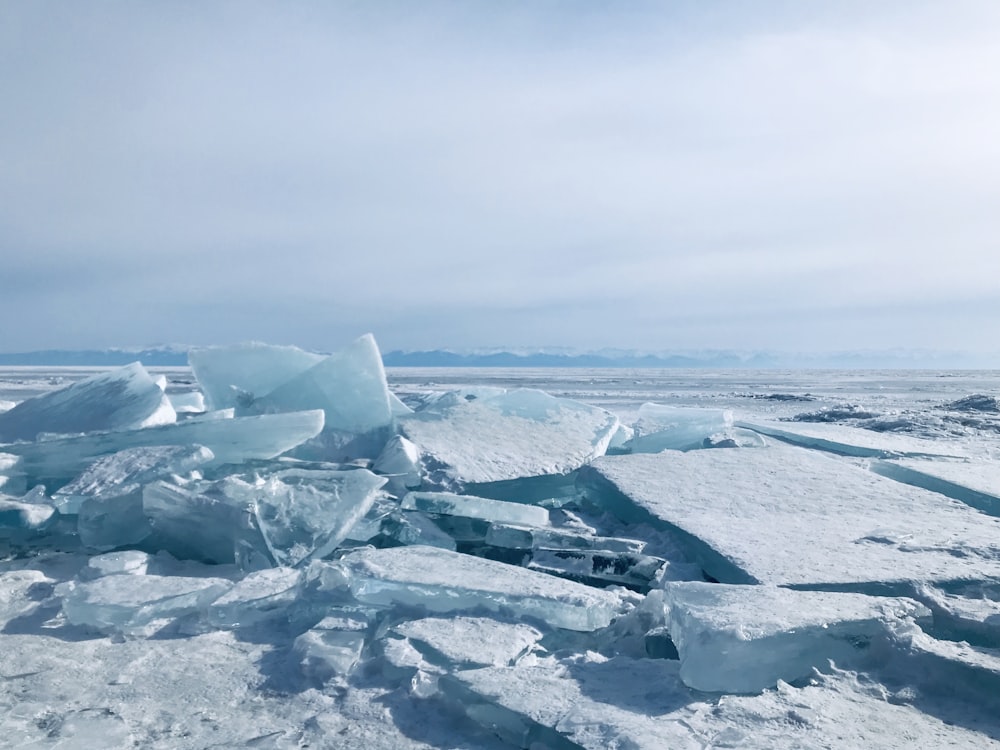a bunch of ice chunks sitting on top of a beach
