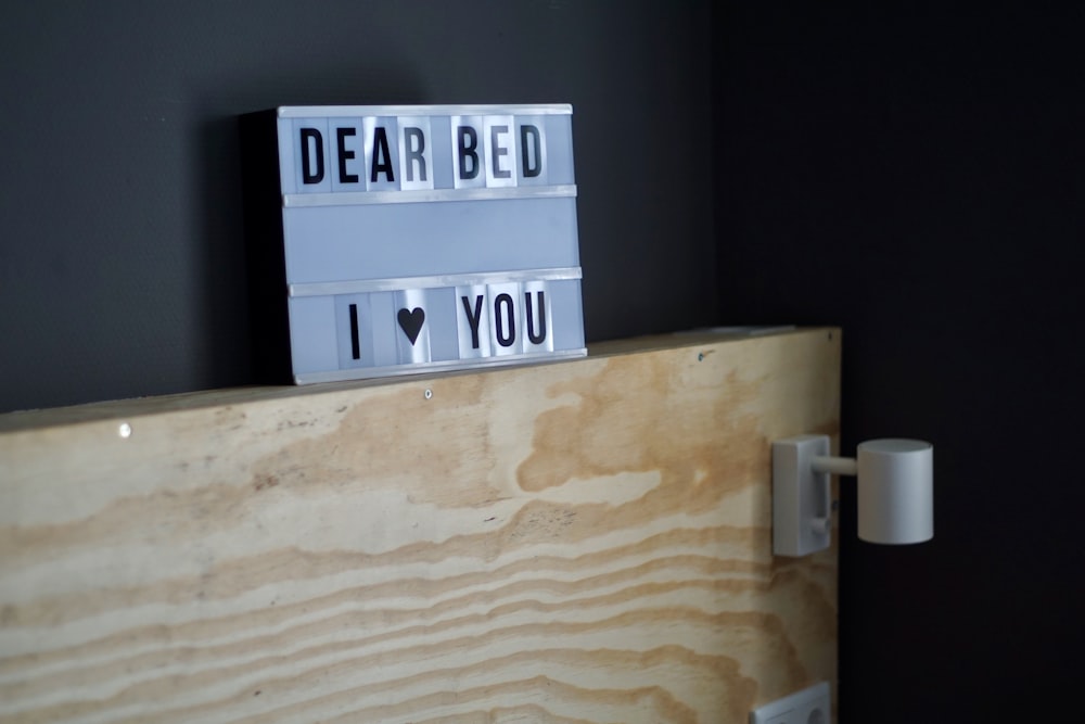 Dear Bed I heart You sign on brown shelf