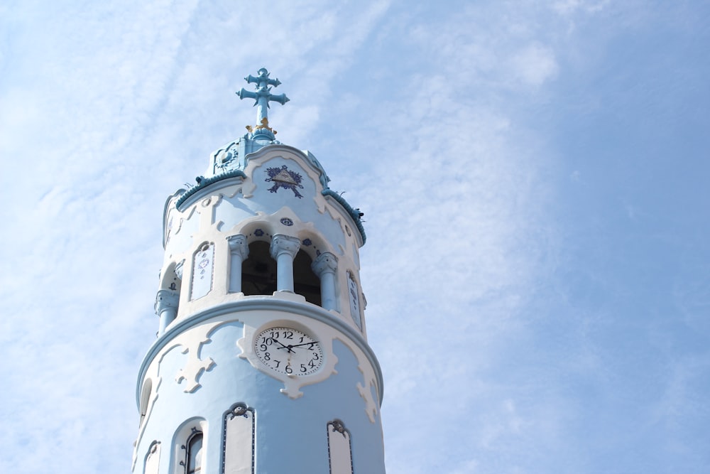 fotografia de baixo ângulo do relógio da torre azul durante o dia