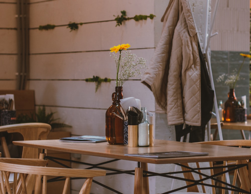 glass bottles and magazines on brown wooden table