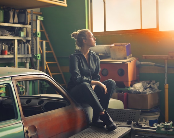 woman sitting on orange vehicle