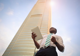 man standing near high-rise building