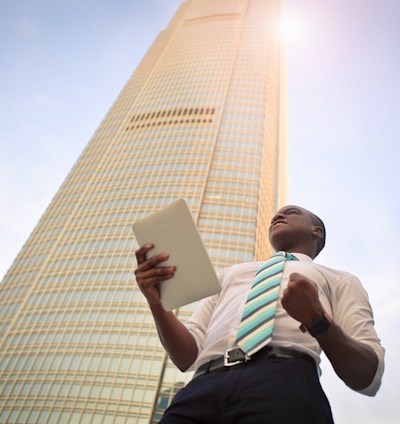 man standing near high-rise building