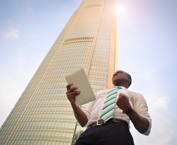 man standing near high-rise building