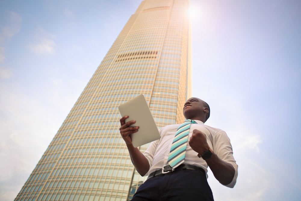 man standing near high-rise building