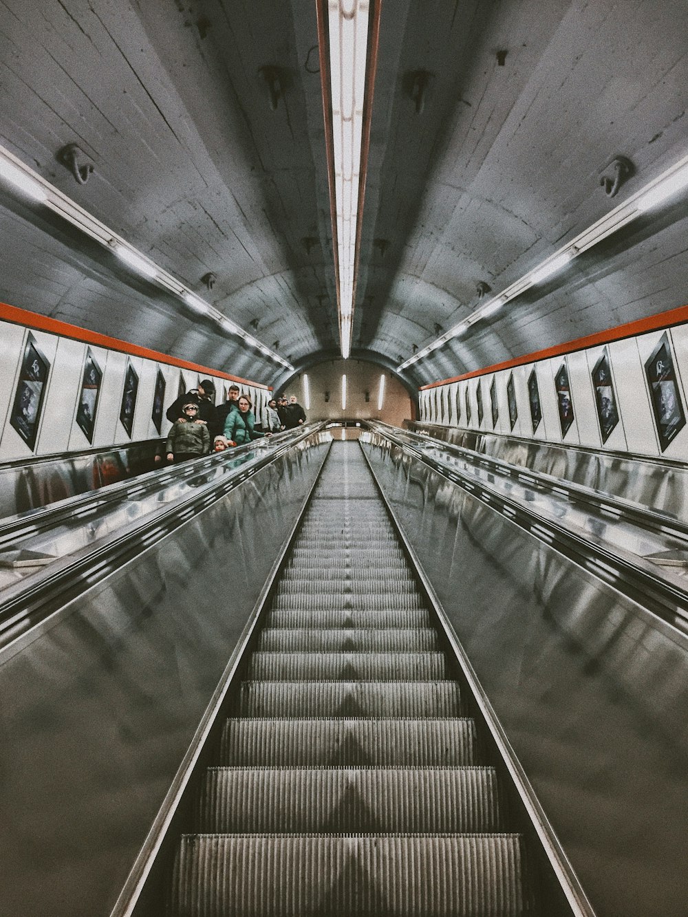 an escalator in a subway station with people on it