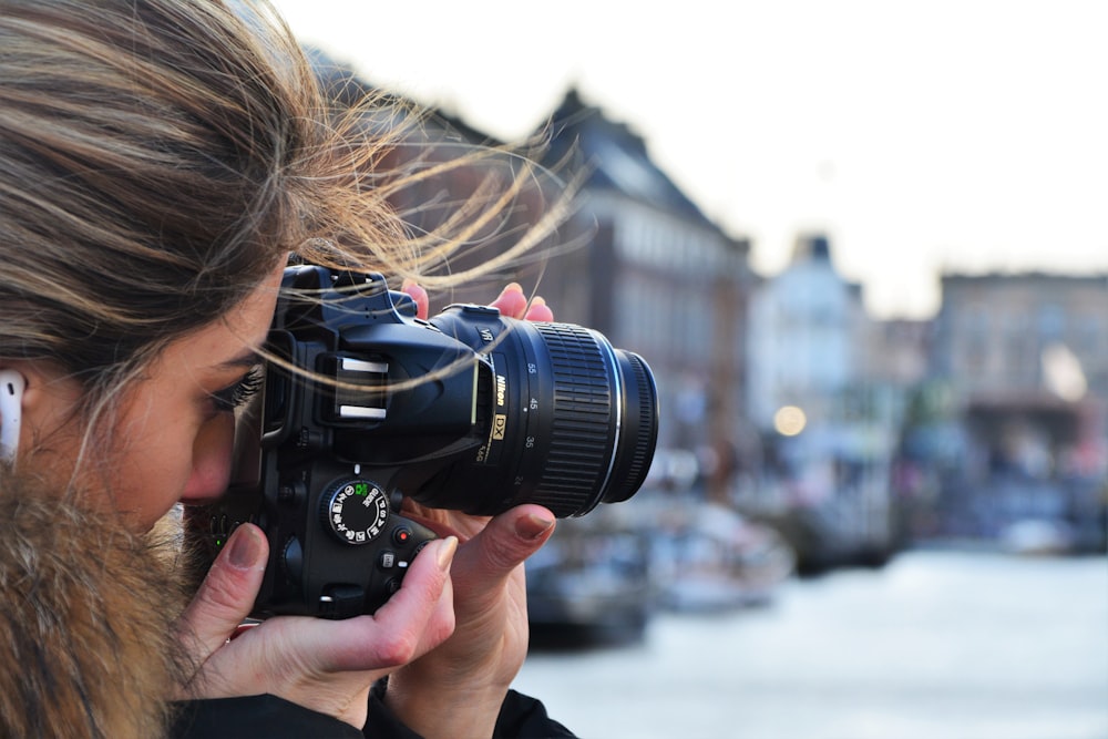 woman using DSLR camera