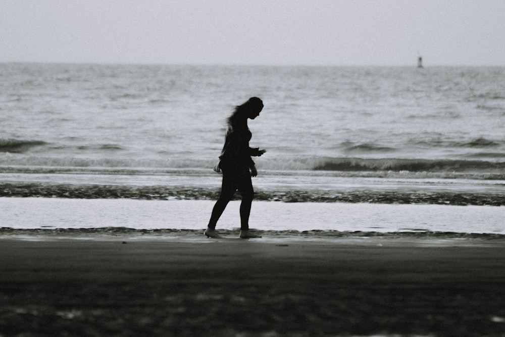 woman walking on seashore