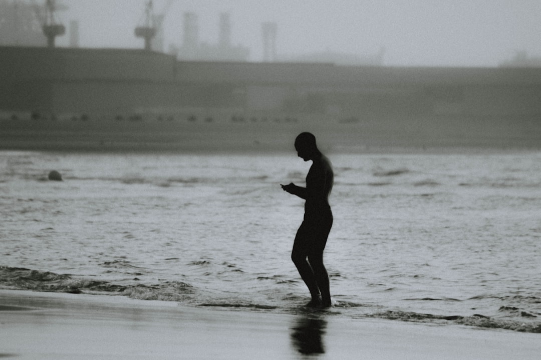 silhouette of person standing on seashores