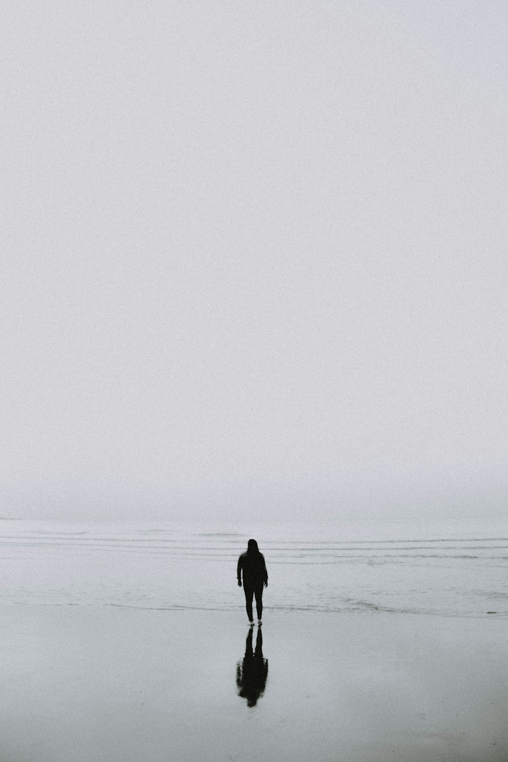 man standing beside seashore