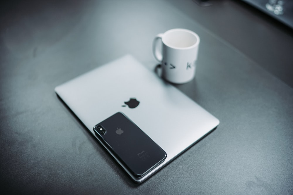 MacBook and white mug