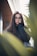 woman standing beside plant