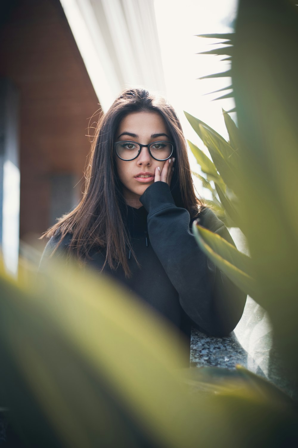 woman standing beside plant