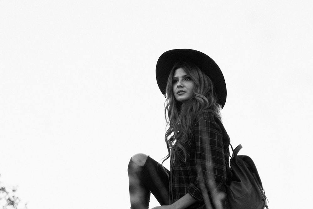 greyscale photography of woman wearing hat