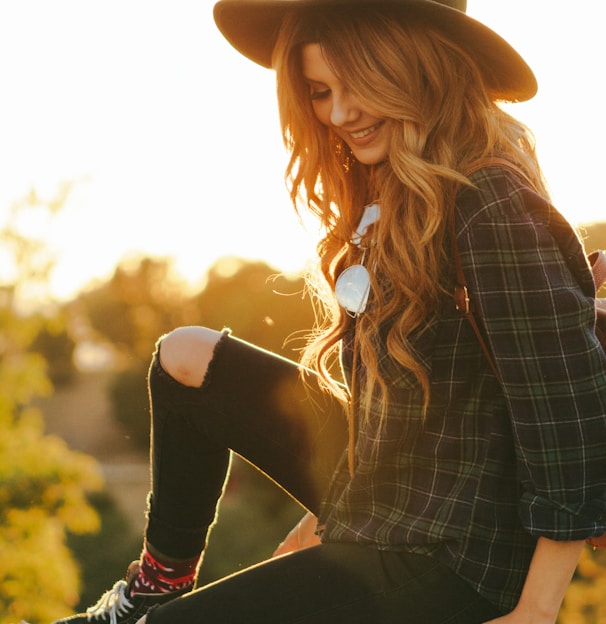 woman waering black blouse and hat