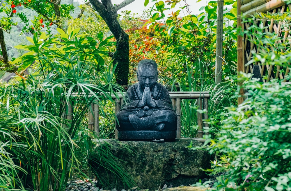 Buddha statue on green rock