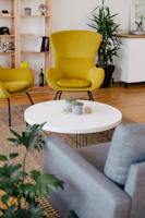 Brightly painted modern living room with yellow accent wall and natural light