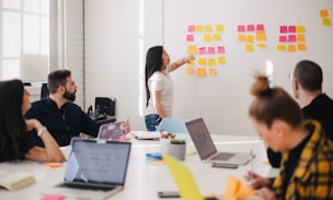 woman placing sticky notes on wall