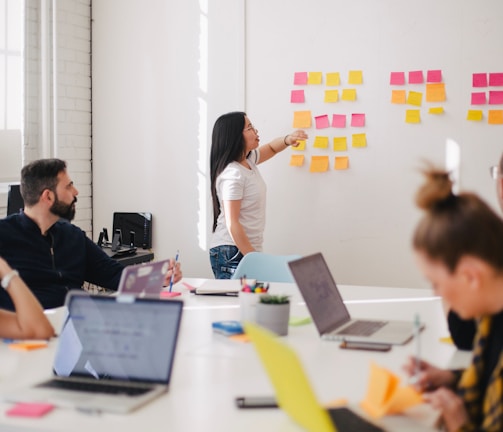 woman placing sticky notes on wall