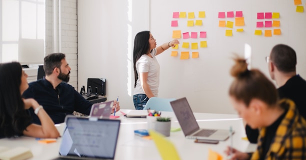 woman placing sticky notes on wall