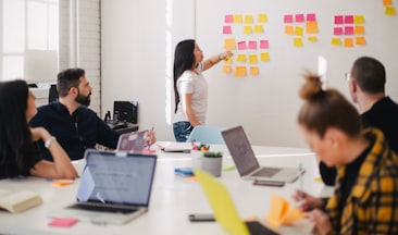 woman placing sticky notes on wall