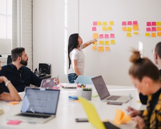 woman placing sticky notes on wall