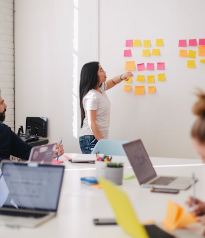 woman placing sticky notes on wall