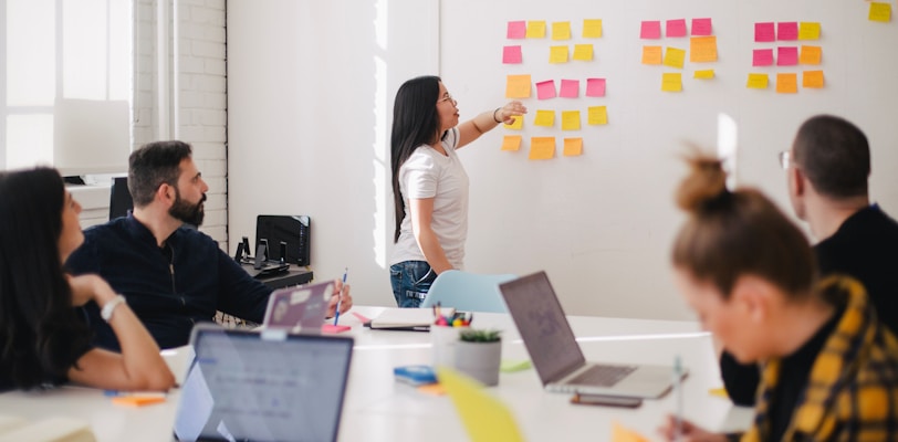 woman placing sticky notes on wall