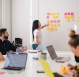 woman placing sticky notes on wall