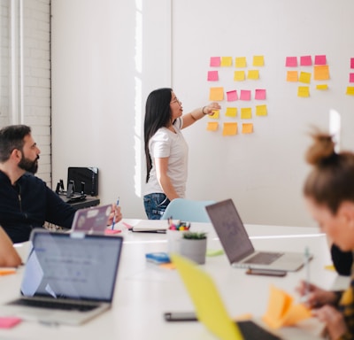 woman placing sticky notes on wall