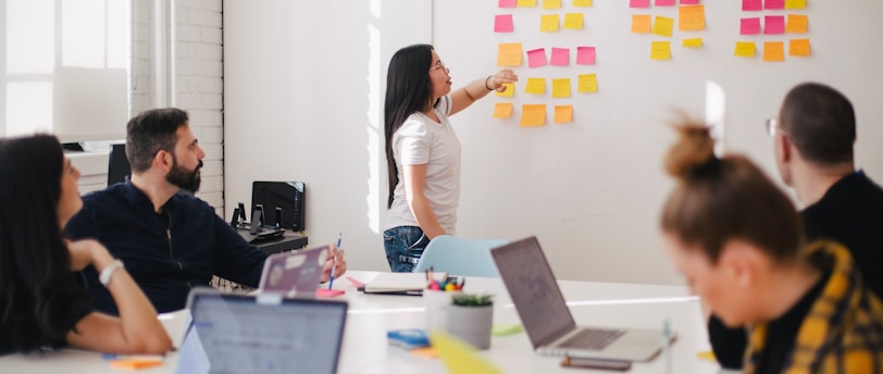 woman placing sticky notes on wall