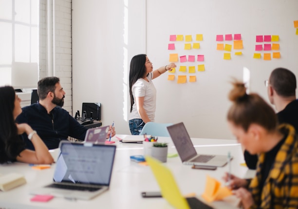 woman placing sticky notes on wall