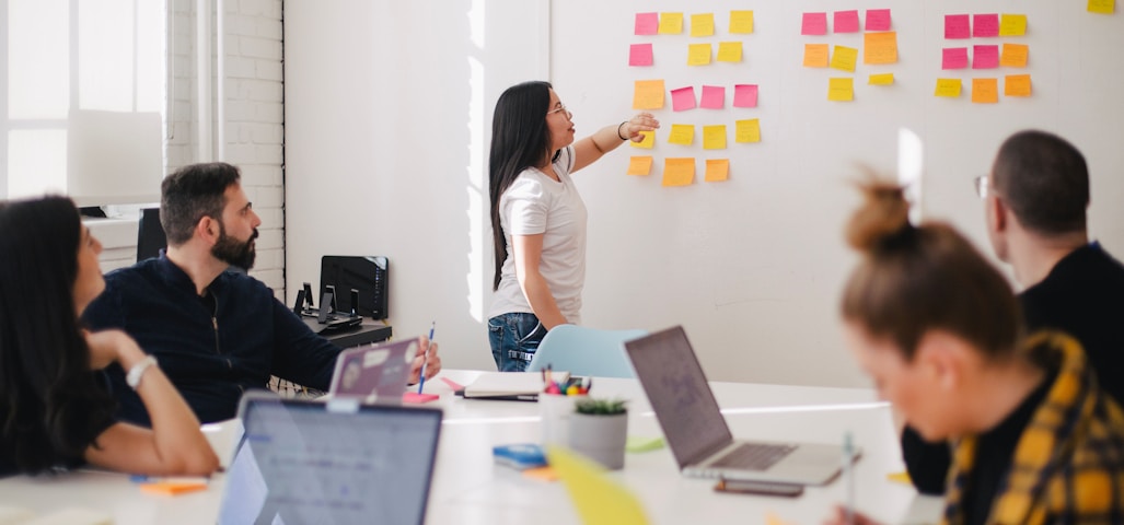 woman placing sticky notes on wall