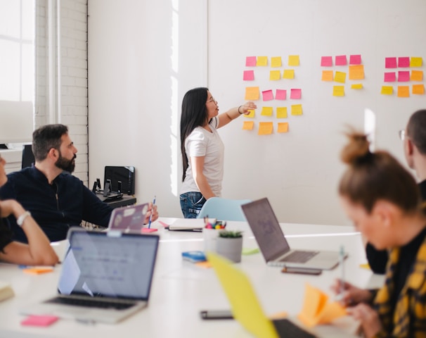 woman placing sticky notes on wall