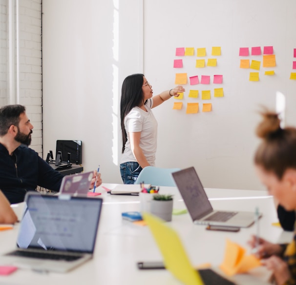 woman placing sticky notes on wall