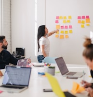 woman placing sticky notes on wall